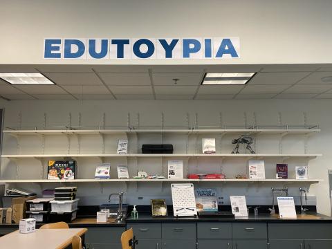The EduTOYpia sign with display shelves below