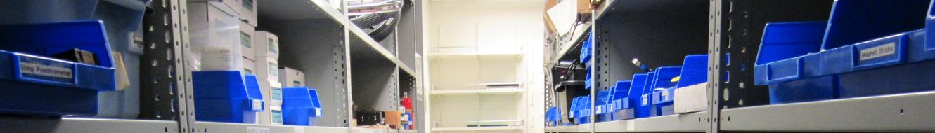 Stockroom shelves with blue bins full of supplies