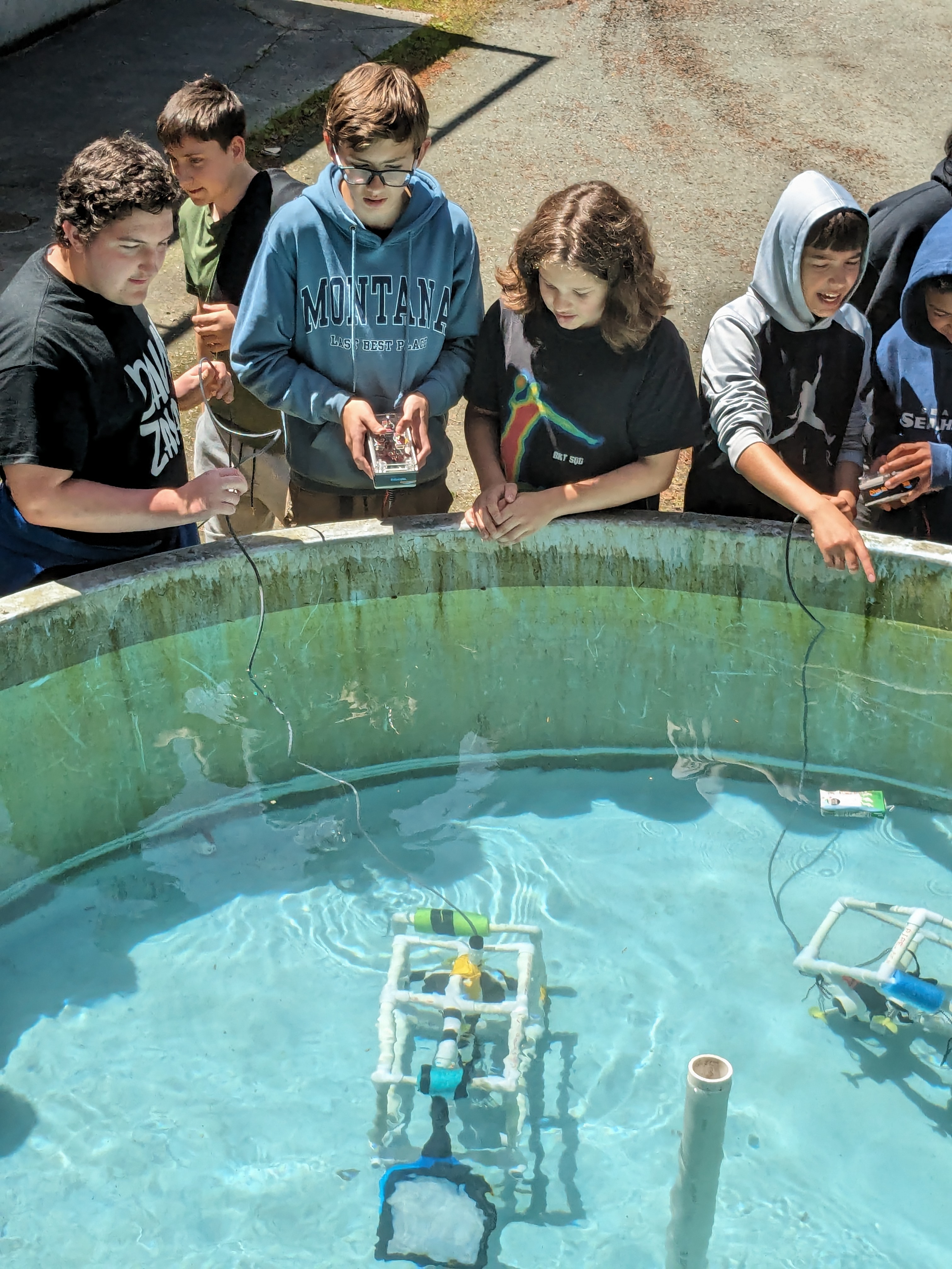 Kids test underwater vehicle in water tank